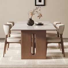 a dining room table with white chairs and a vase on the top, in front of a beige wall