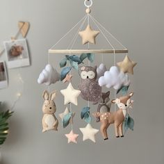 a mobile with animals and stars hanging from it