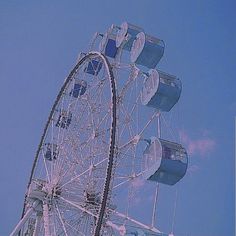 a large ferris wheel sitting on top of a blue sky