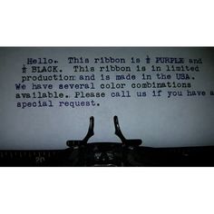 an old typewriter with the words hello this ribbon is purple and black, this ribbon is in ink