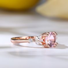 Indulge in the ethereal beauty of the morganite ring, a stunning masterpiece that captures hearts and captivates souls. Crafted with a captivating round-cut morganite as its centerpiece, this ring exudes timeless beauty. The delicate blush hue of the morganite is complemented by the dazzling brilliance of the marquise-cut white stones that gracefully adorn its sides. Embrace the allure of this enchanting piece, where the soft pink hues of the morganite symbolize love and compassion, while the sp Exquisite Morganite Rose Gold Rings, Luxury Morganite Round Ring, Exquisite Rose Gold Morganite Ring, Rose Gold Topaz Ring With Morganite And Accent Stones, Luxury Round Morganite Rings, Exquisite Morganite Rings, Morganite Pink Gold Rings With Accent Stones, Pink Gold Morganite Rings With Accent Stones, Elegant Pink Gold Morganite Rings