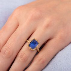 The faceted surface of this exceptional Tanzanite glows with a vibrant, powerful blue. This captivating, one-of-a-kind gemstone is set in a handmade gold setting accented with braided gold and granulated prongs. One of a Kind.Ready to ship in size 7. Please allow 1-2 weeks for any other size. Technical Details Metal: 18k yellow goldTanzanite: 4.56 cts. Ring face: 11.4 x 9.1mmBand width: 2mmHandmade in New YorkStyle # R-2540-TA Jewellery Photography, Ring Hand, Tanzanite Ring, Jewelry Photography, Handmade Gold, Gold Set, Gold Frame, Size 7, Band