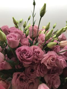 a vase filled with pink flowers on top of a table