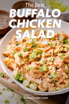 the best buffalo chicken salad in a white bowl with green onions and celery