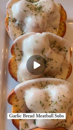 garlic bread meatball subs with white sauce and herbs on top are shown in this video