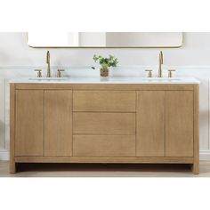 a bathroom vanity with two sinks and a mirror