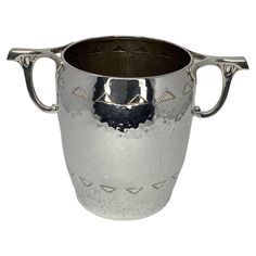 a large silver cup with handles on it