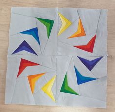 four pieces of paper with different colored triangles on them