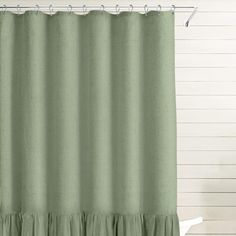 a green shower curtain with ruffled edges