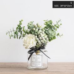 a vase filled with flowers on top of a wooden table