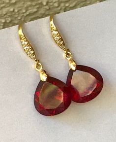 "Burgundy Garnet gold pave earrings. Heart cut garnets. Red stone jewelry. Red garnet dangles. Dark red garnet drops. Junuary birthstone. Available in 3 finishes. Length 1 1/4\". Dark red faceted gems are 14x14 mm as photo are sold, 19x14 mm and 13x17 mm stones are available. These beautiful earrings will arrive in a jewelry box ready for gift giving." Red Synthetic Ruby Earrings, Pear-shaped Ruby Gemstone Earrings, Pear-shaped Ruby Earrings, Ruby Yellow Gold Earrings For Gift, Yellow Gold Ruby Earrings For Gift, Ruby Earrings In Yellow Gold For Gift, Ruby Earrings For Valentine's Day, Wedding Earrings With Lab-created Ruby Gemstone, Elegant Ruby Earrings For Valentine's Day