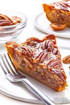 a piece of pecan pie sitting on top of a white plate next to a fork