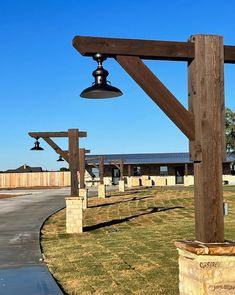 an outdoor area with wooden posts and lights