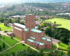 an aerial view of a large building with green roofs