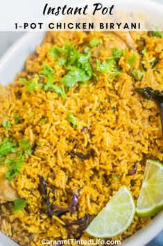 instant pot chicken biriyani in a white bowl with limes and cilantro