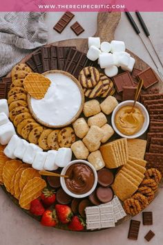 a platter filled with cookies, marshmallows, crackers and chocolate