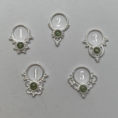 These are soooooo pretty. Made is 925 sterling silver with tribal details, set with a shiny light peridot stone. The rings are all 1cm (.40”) in diameter. The wire is 18 gauge.One of the images contains numbers to specify which you would like from the drop down menu. Sterling Silver Body Jewelry, Nickel-free Silver Peridot Jewelry, Silver Internally Threaded Toe Ring, Silver Stackable Septum Ring, Silver Stackable Round Septum Ring, Hypoallergenic Sterling Silver Body Jewelry, Silver Stackable Septum Ring As Gift, Silver Goddess, Grass Valley