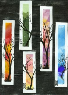 four trees painted on different colored papers