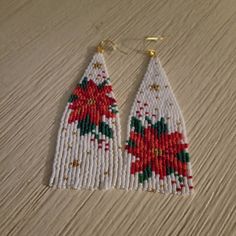 the beaded earrings are decorated with poinsettis