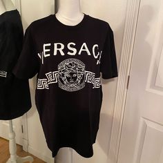 Brand New, Never Been Worn. Black And White Genuine Versace T-Shirt. Designer Black T-shirt With Monogram Print, Black Monogram Print Crew Neck T-shirt, Black Monogram Print Crew Neck Top, Black Crew Neck Top With Monogram Print, Black Designer T-shirt With Monogram Print, Designer Black Monogram Print Top, Designer Black Top With Graphic Print, Designer Black Tops With Logo Print, Designer Black Tops With Graphic Print