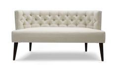 an upholstered couch with wooden legs and tufted backrests, on a white background