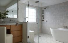 a bathroom with a tub, sink and mirror