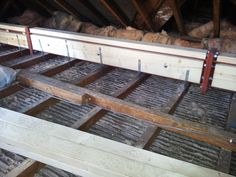 an unfinished room with wooden flooring and exposed beams in the ceiling, along with other wood planks