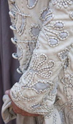 the pants are decorated with flowers and beads on them, as if they were made out of fabric