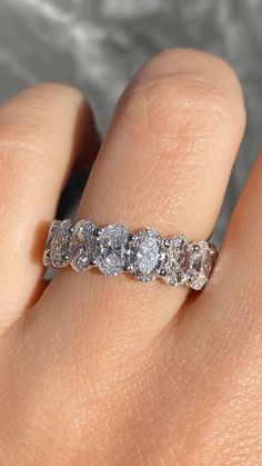 a woman's hand with a diamond ring on it