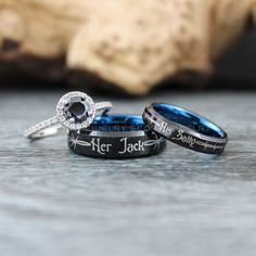 two wedding rings with the words her and hers engraved on them, sitting next to each other