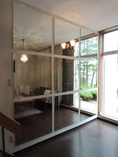 an empty living room with large glass doors