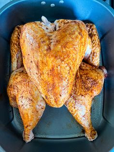 a whole chicken in a frying pan on the stove