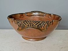 a brown bowl sitting on top of a white counter