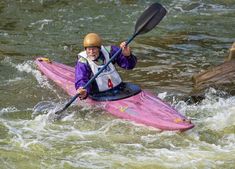 a man in a kayak paddles through the water