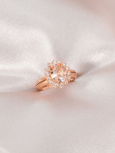 an engagement ring on a white satin background