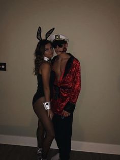 two people dressed up in costumes posing for the camera with one person wearing bunny ears