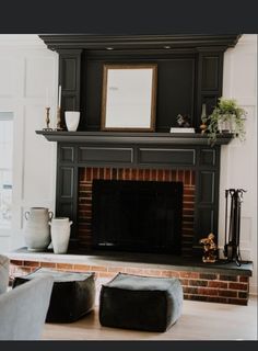 a living room filled with furniture and a fire place in front of a brick fireplace