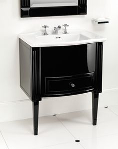 a bathroom sink sitting under a mirror next to a wall mounted faucet in front of a white tiled floor