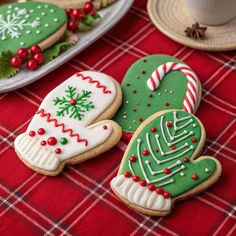 decorated christmas cookies on a red table cloth