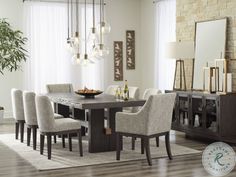 a dining room table surrounded by chairs and a rug