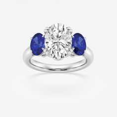 three stone engagement ring with two blue sapphire stones on the side and one white diamond in the center