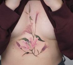 a woman's stomach with pink flowers on it