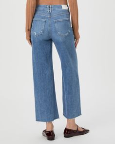 This ultra high-waisted wide leg has an easy, relaxed fit and an ankle length silhouette. This pair is crafted from our PAIGE VINTAGE denim in the perfect light wash with lived-in distressing, natural fading, set in front pockets, double belt loops and a raw hem. PAIGE Vintage takes all of the work out of breaking in your favorite pair of vintage jeans. We've combined the comfort of stretch with everything you love about authentic vintage denim to create super soft jeans that feel perfectly lived-in from the very first wear. Distressed High Rise Cropped Jeans In Washed Blue, High Rise Washed Blue Distressed Cropped Jeans, High Rise Distressed Washed Blue Cropped Jeans, Wide Leg Washed Cropped Jeans For Spring, Spring Cropped Distressed Jeans, Medium Wash Wide Leg Cropped Jeans With Frayed Hem, Wide Leg Washed Blue Cropped Jeans For Spring, Faded Wide Leg Cropped Jeans, Light Wash Wide Leg Cropped Jeans With Frayed Hem