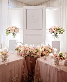 the table is set up with flowers and candles for an elegant wedding reception in pink