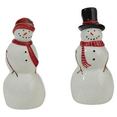 two ceramic snowmen wearing hats and scarves