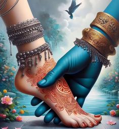 two feet with hendi tattoos and bracelets on them, one is holding the other's hand