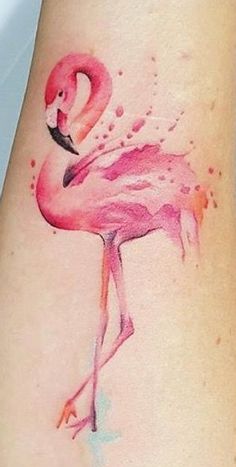 a watercolor flamingo tattoo on the ankle is shown in pink and orange colors