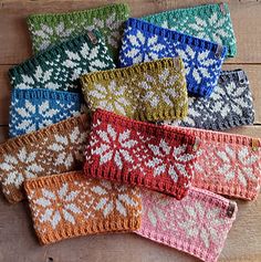 six knitted wrist warmers in various colors and patterns on a wooden surface with text overlay