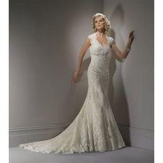 a woman in a wedding dress is posing for the camera with her arms out and hands behind her back