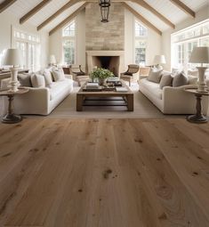 a living room filled with furniture and a fire place in the middle of a room